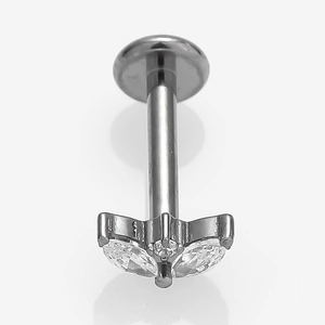 Macro detail of G23 titanium labret stud featuring a butterfly zircon wing design