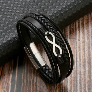 Detail of multi-layer braided leather bracelet with silver infinity symbol and magnetic clasp