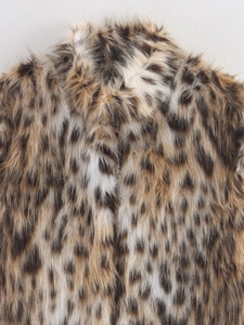Close-up of leopard print faux fur texture showing soft plush fibers and collar detail