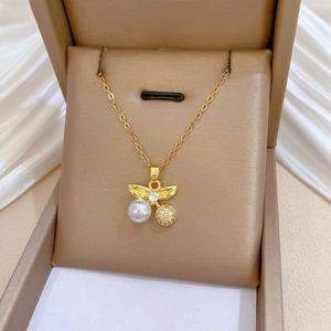 Detail of gold pendant necklace with pearl and crystals in premium jewelry box
