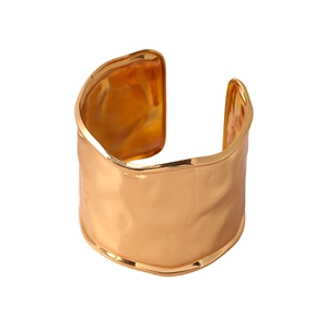 Minimalist wide open cuff bracelet with hammered gold texture and irregular wave edges