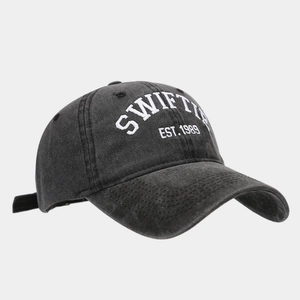 Detail of Swiftie EST. 1989 embroidery on a vintage washed black denim baseball cap