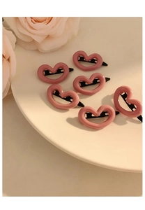 Set of 6 sweet pink heart-shaped hair clips with a glossy finish on a white plate