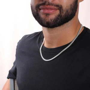 Punk style silver stainless steel Cuban chain necklace worn by a male model