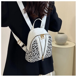 Rear view of a stylish white leopard print mini backpack with dual gold zippers