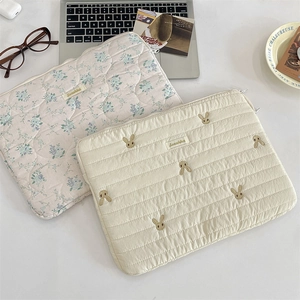 Detail of quilted tablet sleeve with floral patterns and cute rabbit embroidery decoration