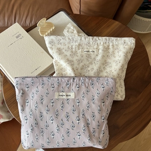 Detail of floral cotton makeup bags with drawstring closure and simple wish labels