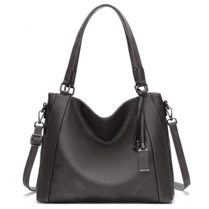 Detailed view of large dark grey faux leather tote bag with dual handles and strap