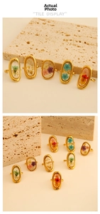Macro display of assorted dried flowers embedded in oval golden stainless steel rings