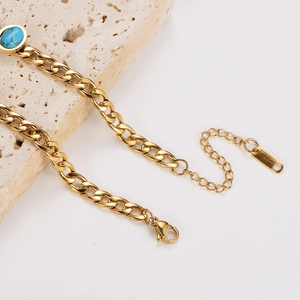 Gold stainless steel curb chain bracelet featuring oval turquoise stone inlays