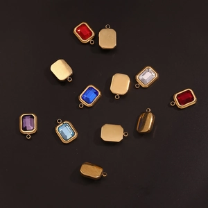 Macro shot of 18K gold plated rectangular pendant set with vibrant colorful gemstones