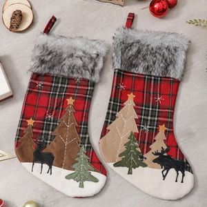 Large Christmas stocking with red plaid fabric, faux fur trim, and reindeer embroidery