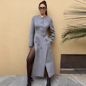 Long grey wool blend coat featuring single-breasted buttons and stylish high side slits