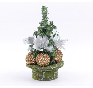 Mini Christmas tree with pine needles, silver glitter flowers, and colorful festive ornaments