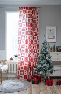 Detail of red and white plaid Christmas curtain with decorative tassels in a festive room