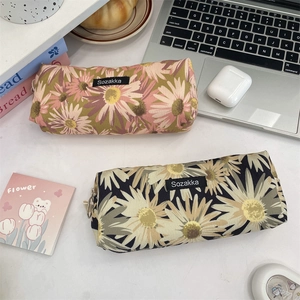 Detailed top view of large capacity floral daisy canvas pencil case on desk