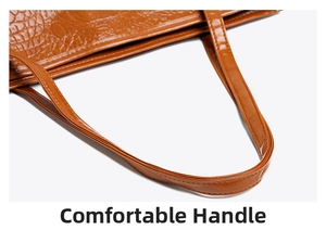 Detail of the comfortable handle on the brown crocodile embossed tote bag
