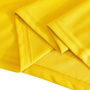 Detailed close-up showing the bright yellow pique knit fabric and premium double stitching