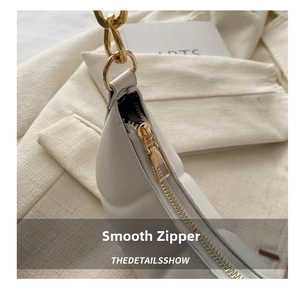 Macro shot of smooth gold metal zipper and white quilted leather on women shoulder bag