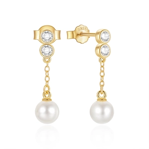 Macro detail of gold S925 sterling silver tassel earrings with pearls and zircon stones