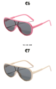 Side view detail of oversized one-piece kids sunglasses in pink and beige finishes