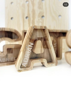 Close-up of oak wood letter A piggy bank with transparent acrylic and custom name