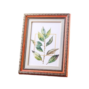 European vintage photo frame with wood grain finish and gold embossed floral patterns