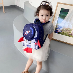 Toddler in blue rocket backpack with astronaut suit design and clear helmet pocket