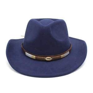 Detail of navy blue felt wide brim hat with ethnic woven band and golden shell buckle