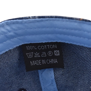 Detail of the 100% cotton label and stitching inside a washed denim baseball cap
