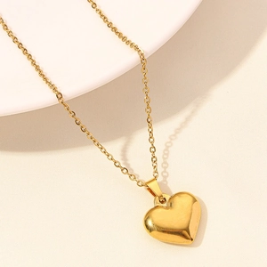Detailed close-up of 18k gold plated heart pendant necklace with mirror polished finish