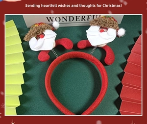 Detail of red Christmas headband featuring spring-mounted Santa Claus dolls with sequins