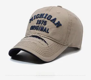Close-up of vintage khaki baseball cap with MICHIGAN embroidery and distressed torn brim