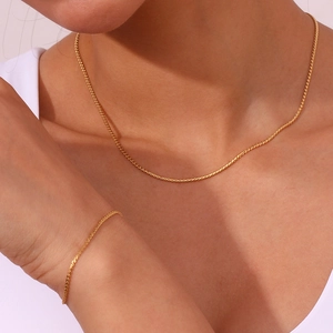Detailed view of minimalist 18K gold plated stainless steel necklace and bracelet set