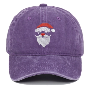 Close-up of Santa Claus embroidery on vintage washed purple cotton baseball cap