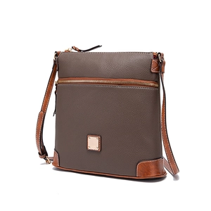Close-up of pebble leather texture and gold zipper on dark brown crossbody bag