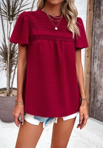 Detail of burgundy short sleeve top featuring lace patchwork and swiss dot fabric texture