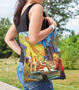 Outdoor model shot of a canvas tote bag featuring Van Gogh style artistic oil painting print