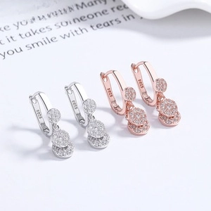 Detail view of 925 sterling silver drop earrings with pavé set zircon discs and S925 hallmark