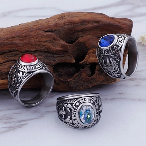 Detailed shot of retro military rings featuring red, blue, and white gems with eagle relief