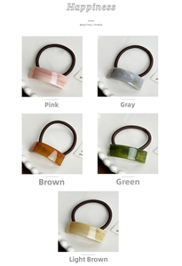 Detail of high-elasticity hair ties with five colors of marbled acetate and gold lettering
