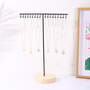Minimalist black iron T-bar necklace display stand with natural wooden base for jewelry