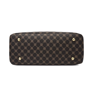 Detail view of handbag base with golden protective studs and printed geometric pattern