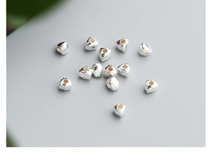 Detailed macro view of S925 sterling silver geometric heart spacer beads for jewelry DIY
