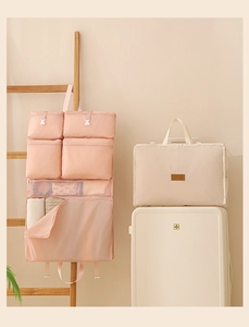 Pink hanging toiletry organizer and beige folded storage bag for travel luggage packing