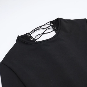 Detailed view of the lace-up eyelet design on the neck of this black bodycon dress