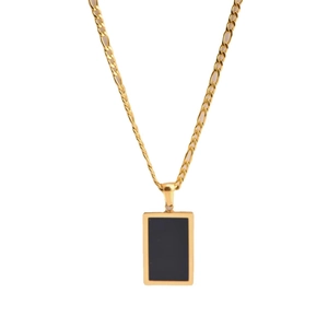 Minimalist gold Figaro chain necklace featuring a rectangular black shell pendant on white background