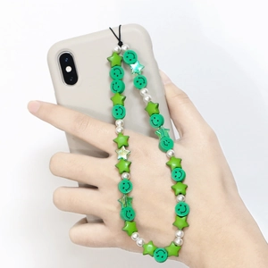 Bohemian phone charm with green star beads, smiley faces, and white faux pearls