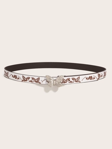 Detail of white Y2K belt featuring brown butterfly patterns and a silver butterfly buckle