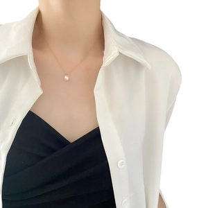 Elegant French vintage necklace featuring a single natural pearl on a gold titanium steel chain